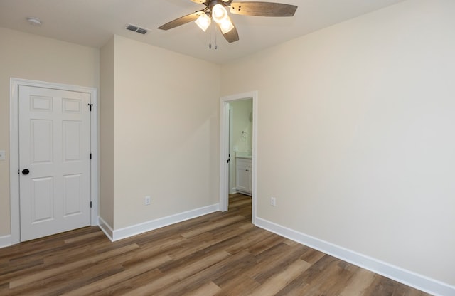 spare room featuring ceiling fan and dark hardwood / wood-style flooring