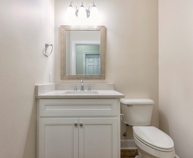 bathroom featuring vanity and toilet