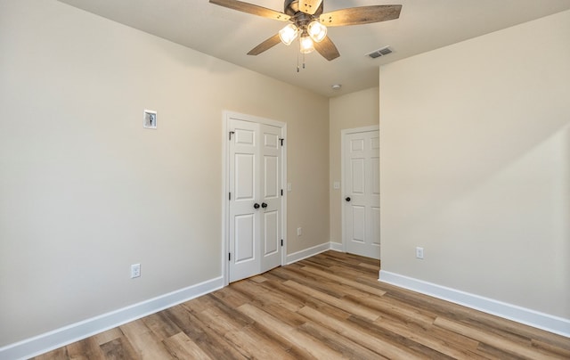 empty room featuring ceiling fan and light hardwood / wood-style floors