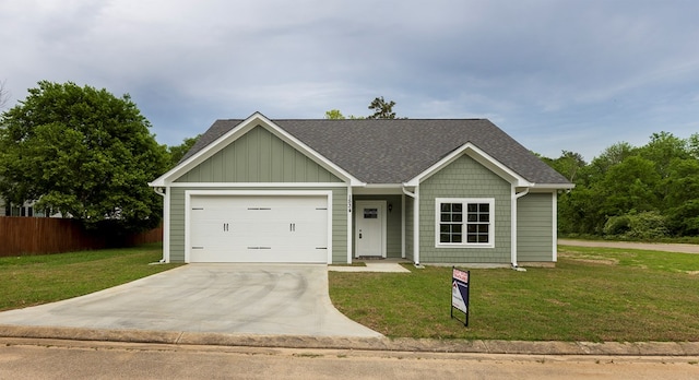 view of front of property with a garage and a front yard