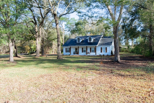 cape cod house with covered porch and a front yard