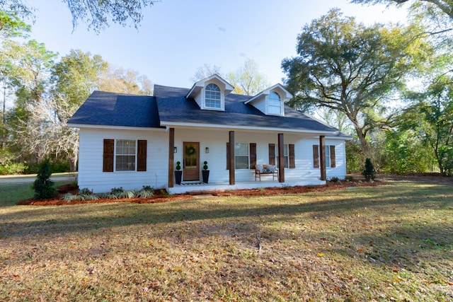view of front of home with a porch and a front lawn