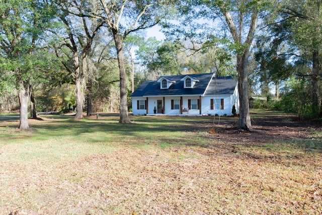 cape cod home featuring a porch and a front lawn