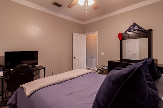 bedroom featuring ornamental molding, visible vents, and ceiling fan