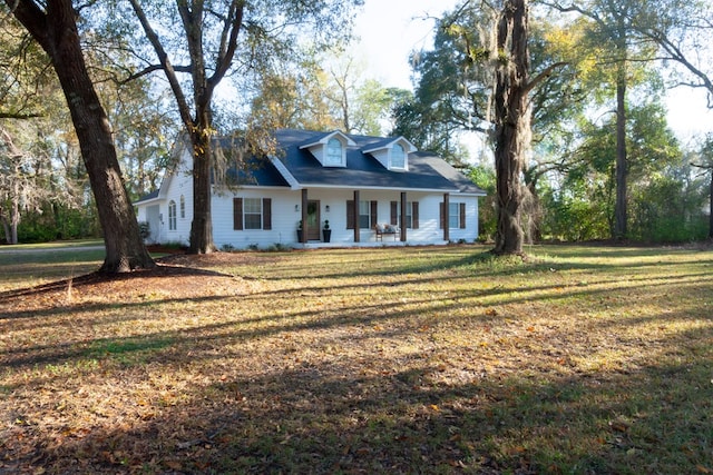 cape cod house featuring a porch and a front lawn