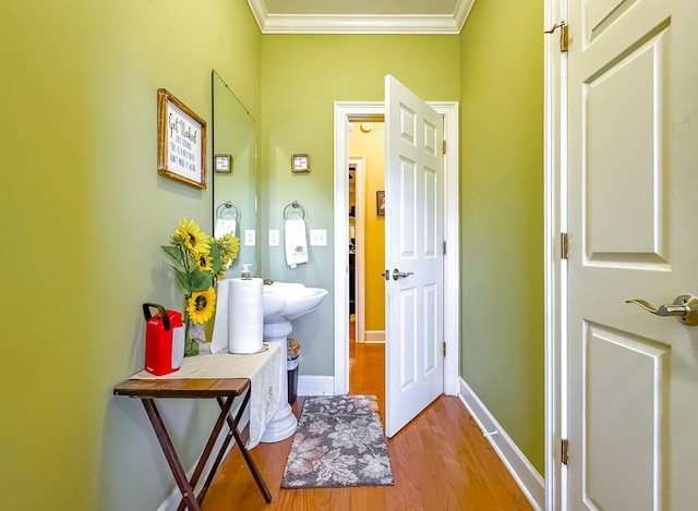 bathroom with hardwood / wood-style floors and crown molding