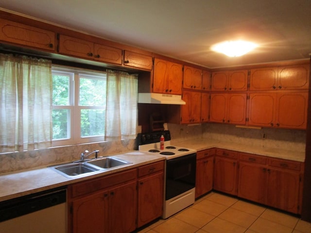 kitchen with white appliances, sink, light tile patterned floors, and tasteful backsplash