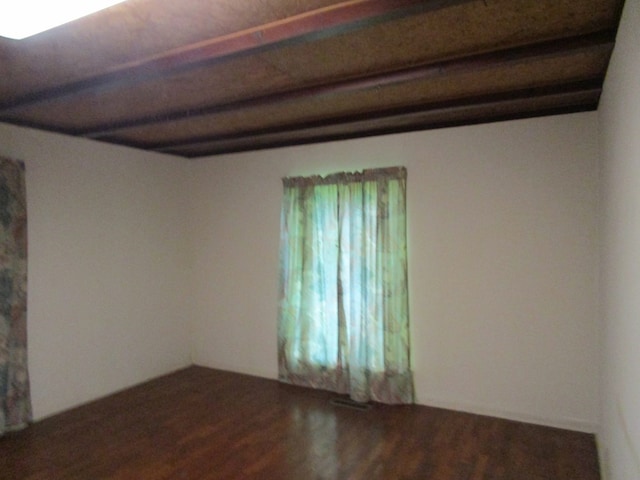 unfurnished room featuring dark wood-type flooring