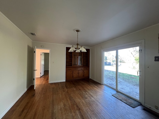 unfurnished dining area with ornamental molding, a notable chandelier, and dark hardwood / wood-style floors