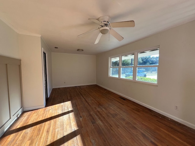 unfurnished room with ceiling fan and dark wood-type flooring