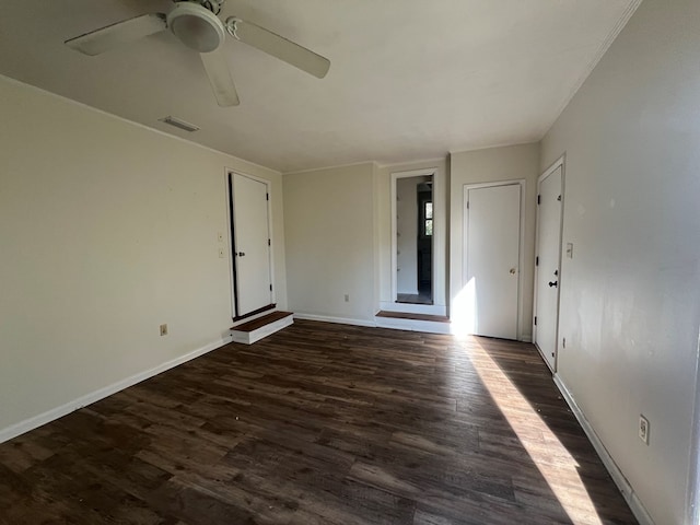 empty room featuring ceiling fan and dark hardwood / wood-style flooring