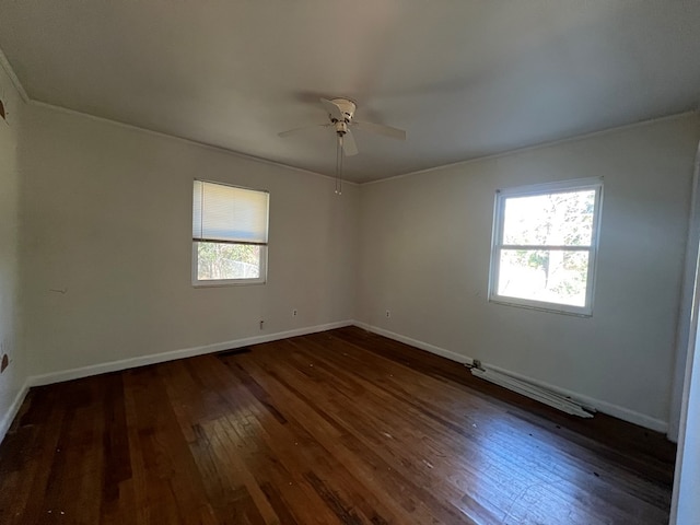 unfurnished room with ceiling fan, dark hardwood / wood-style flooring, and ornamental molding