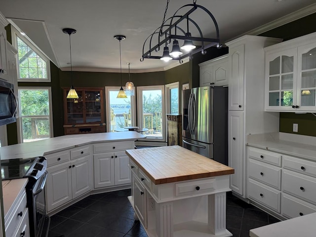 742 Booster Club Rd, Bainbridge, GA 39819 - kitchen with appliances with stainless steel finishes, wood counters, dark tile patterned flooring, white cabinetry, and glass insert cabinets