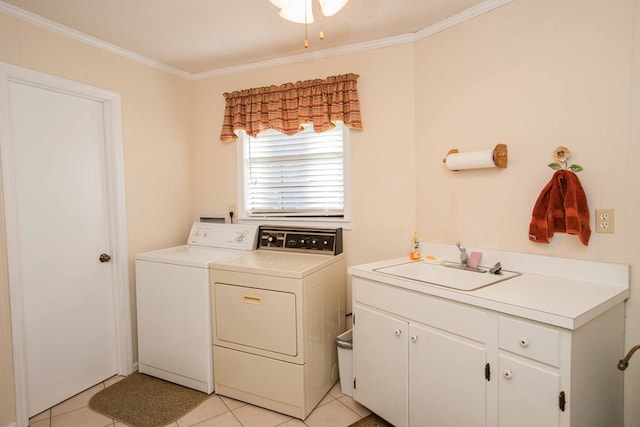 laundry room with sink, cabinets, light tile patterned floors, ornamental molding, and washer and clothes dryer