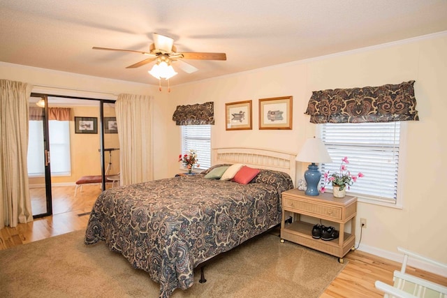 bedroom featuring ornamental molding, ceiling fan, and light wood-type flooring