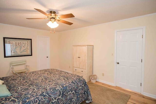 bedroom with crown molding, light hardwood / wood-style floors, and a textured ceiling