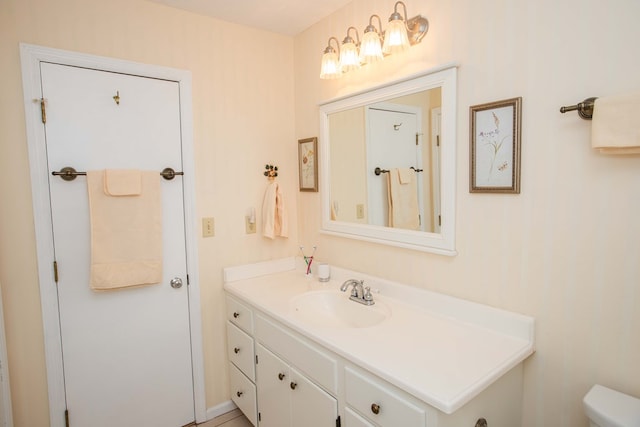 bathroom featuring vanity and toilet