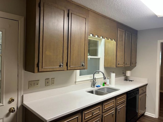 1355 SE Brookwood Dr, Cairo, GA 39828 - kitchen featuring a sink, light countertops, a textured ceiling, dark wood finished floors, and black dishwasher