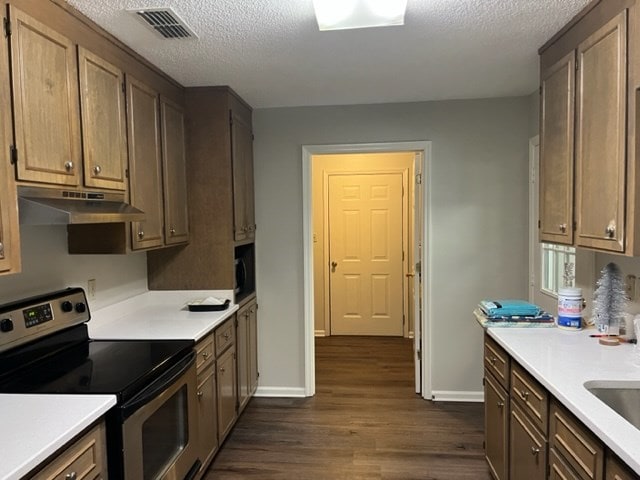 kitchen featuring stainless steel electric range oven, dark wood-type flooring, and a textured ceiling