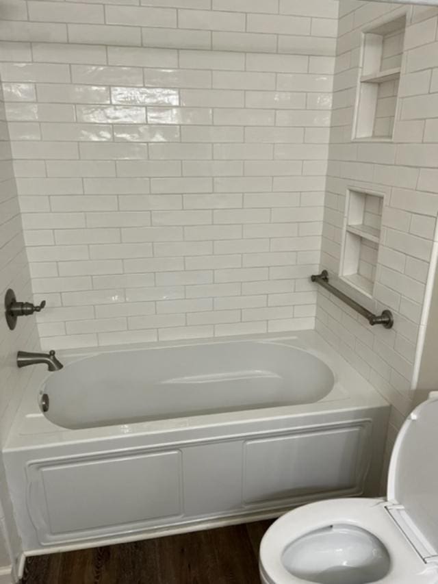 1355 SE Brookwood Dr, Cairo, GA 39828 - bathroom with toilet, wood finished floors, and shower / bathing tub combination