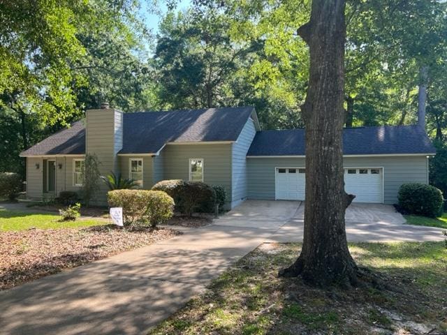 1355 SE Brookwood Dr, Cairo, GA 39828 - view of front of property with a garage, a chimney, and concrete driveway