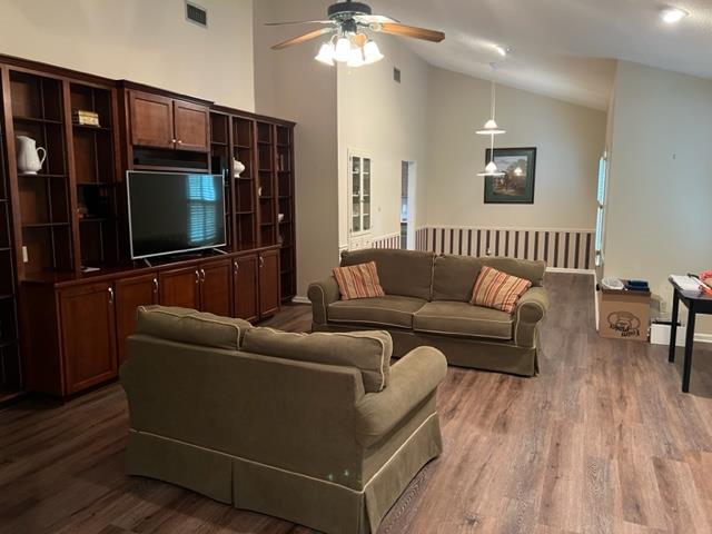1355 SE Brookwood Dr, Cairo, GA 39828 - living area featuring visible vents, a ceiling fan, wood finished floors, and high vaulted ceiling