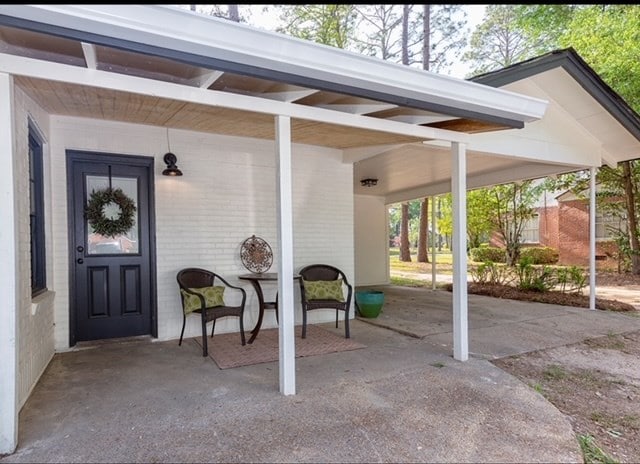 view of exterior entry featuring a carport