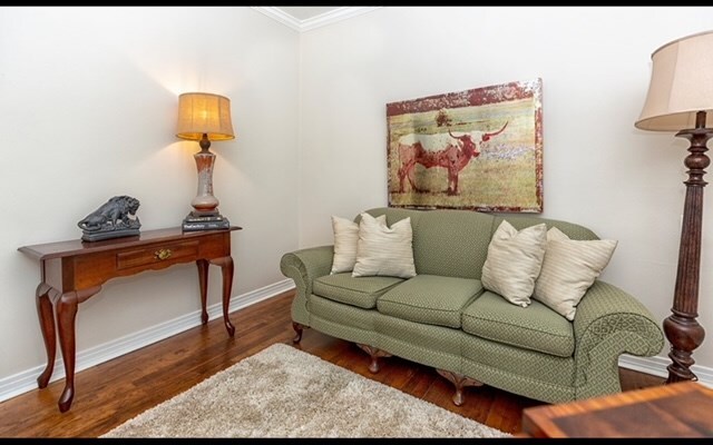 sitting room featuring dark hardwood / wood-style flooring and crown molding