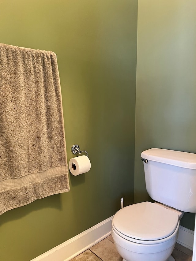 bathroom with toilet and tile patterned floors