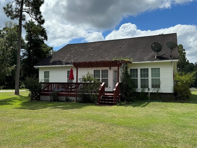 rear view of property featuring a lawn and a wooden deck