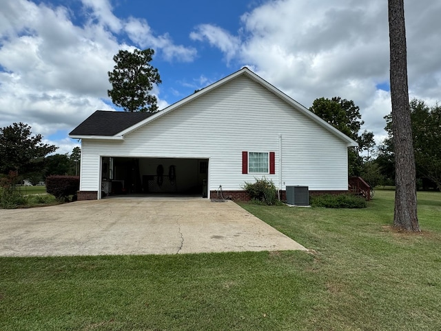 view of home's exterior featuring a yard, a garage, and central air condition unit