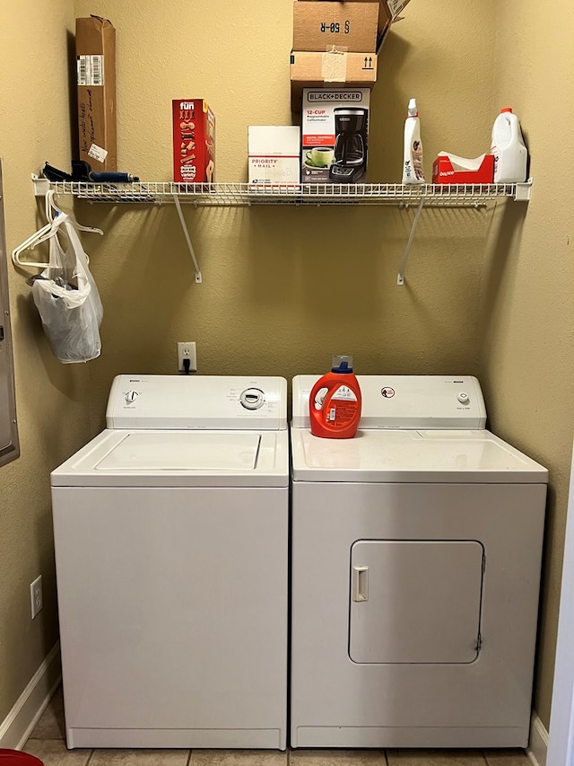 laundry room with tile patterned flooring and washer and dryer