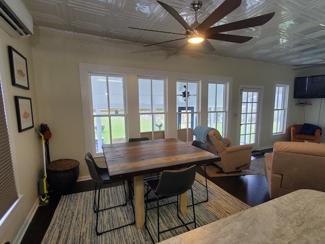 dining area featuring a ceiling fan, wood finished floors, baseboards, an ornate ceiling, and a wall mounted air conditioner