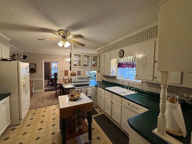 1001 Hall St, Bainbridge, GA 39819 - kitchen with white appliances, ornamental molding, ceiling fan, wallpapered walls, and dark countertops