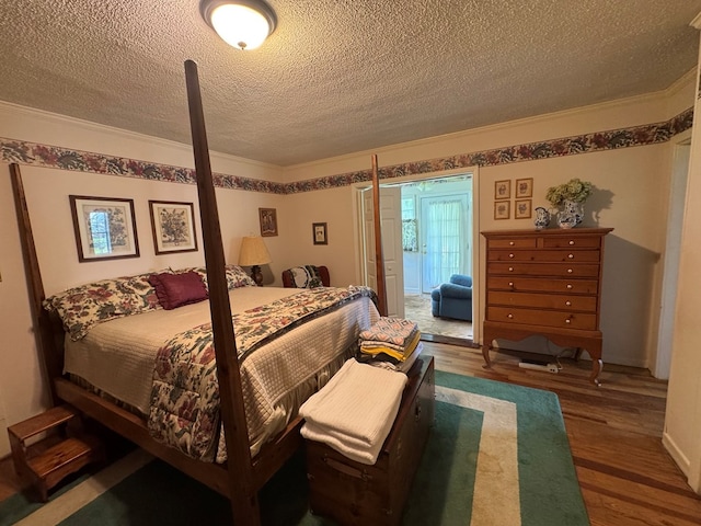 1001 Hall St, Bainbridge, GA 39819 - bedroom with wood finished floors, a textured ceiling, and crown molding