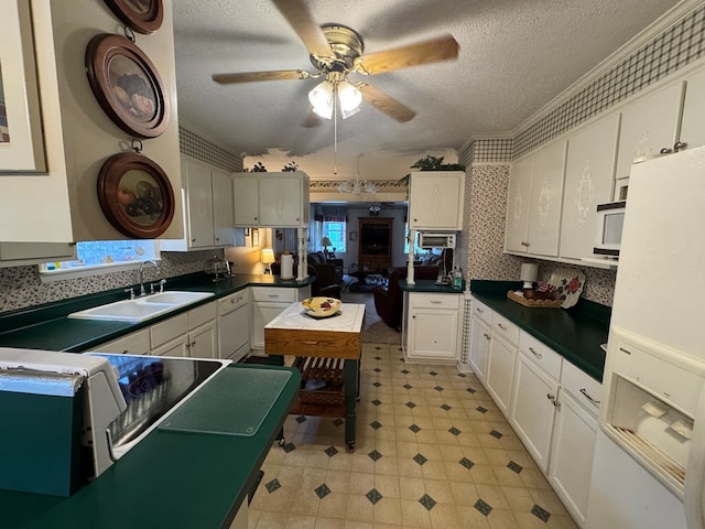 1001 Hall St, Bainbridge, GA 39819 - kitchen featuring white appliances, white cabinetry, a textured ceiling, a ceiling fan, and dark countertops