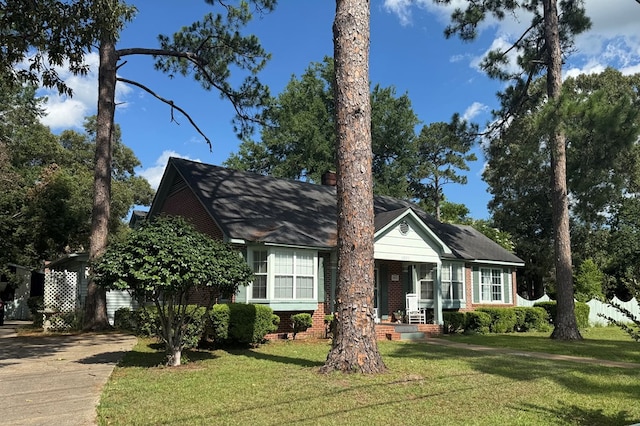 1001 Hall St, Bainbridge, GA 39819 - view of front facade featuring a front lawn, brick siding, a porch, and concrete driveway