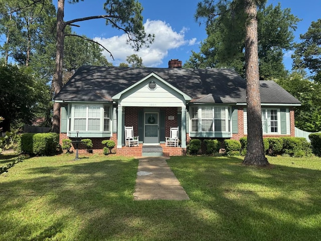 1001 Hall St, Bainbridge, GA 39819 - view of front of home with brick siding, a chimney, and a front yard