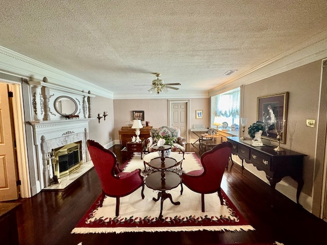 1001 Hall St, Bainbridge, GA 39819 - living room featuring crown molding, wood finished floors, a high end fireplace, a textured ceiling, and ceiling fan