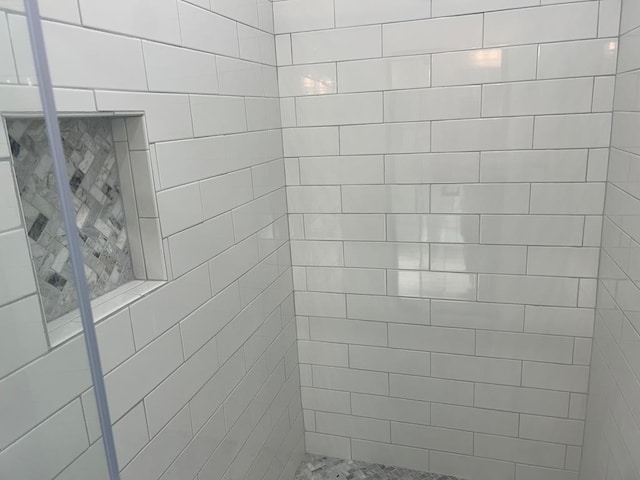 bathroom with a tile shower