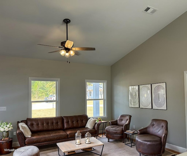 living room with ceiling fan and lofted ceiling