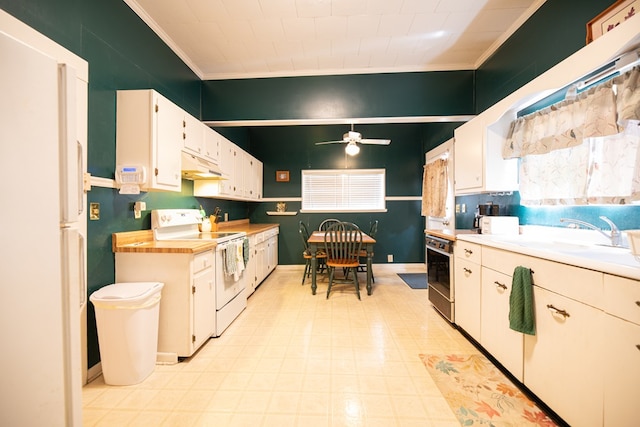 kitchen featuring crown molding, a sink, under cabinet range hood, white appliances, and white cabinetry