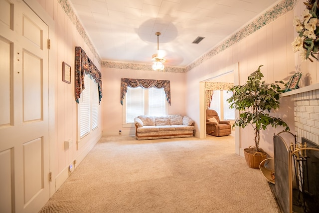 living area with ceiling fan, visible vents, carpet, and a fireplace