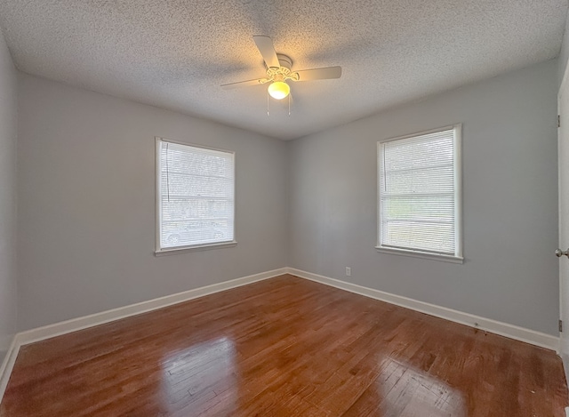 empty room with a textured ceiling, hardwood / wood-style floors, and ceiling fan