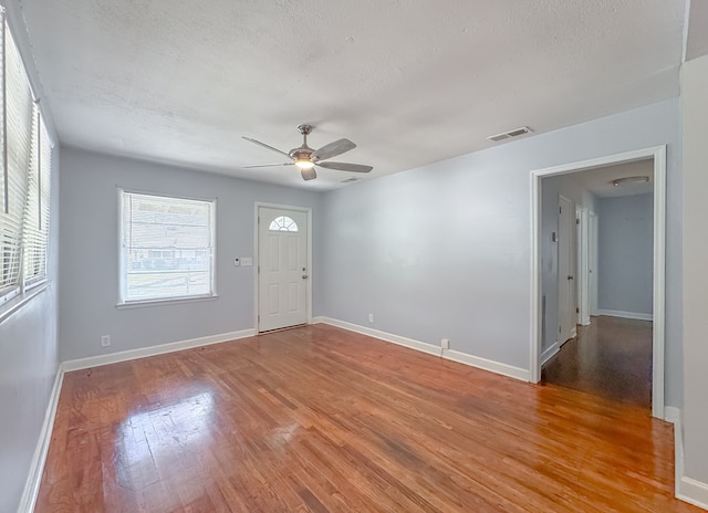 entryway with light wood-type flooring, a textured ceiling, and ceiling fan