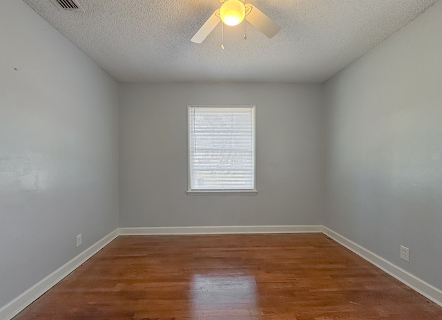 unfurnished room featuring hardwood / wood-style flooring, ceiling fan, and a textured ceiling