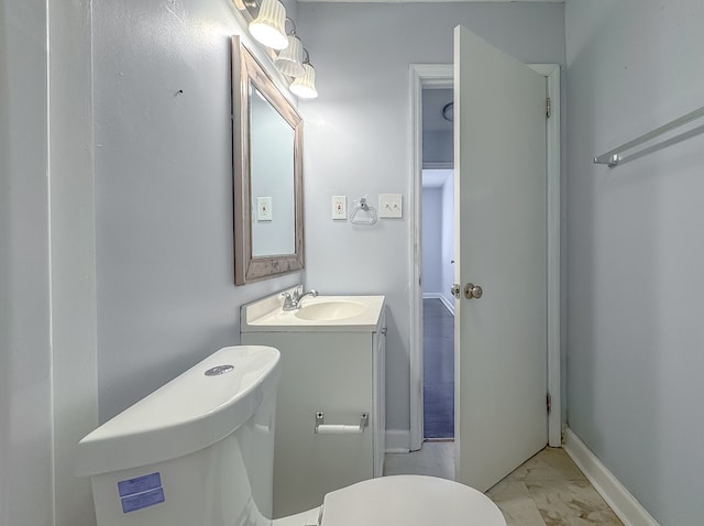 bathroom with toilet and vanity