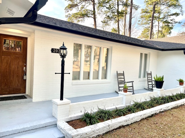 property entrance with covered porch