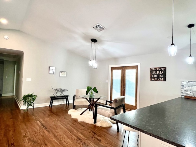 unfurnished dining area featuring lofted ceiling, dark hardwood / wood-style flooring, and french doors