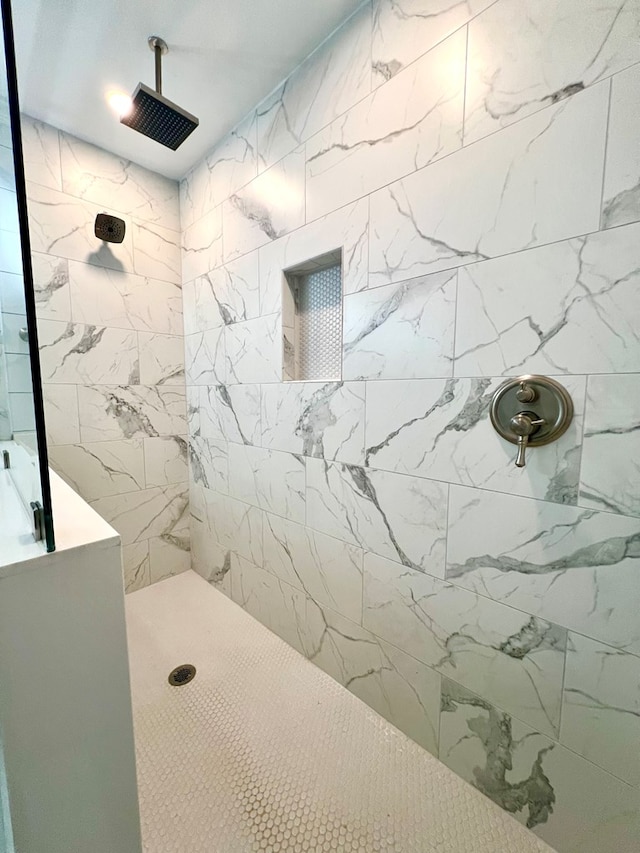 bathroom with a tile shower